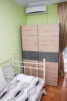 a bedroom with a bed and a large wooden headboard at Red Clay Apartments City Club in Belgrade