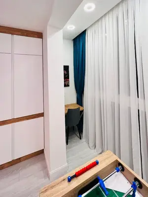a room with a ping pong table and a desk at Vivio 2 Luxury Apartment in Belgrade