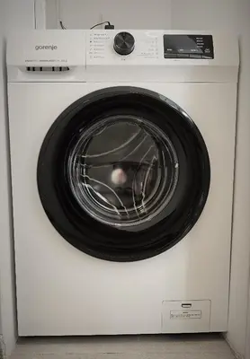 a white washing machine with a black door at Vivio 2 Luxury Apartment in Belgrade