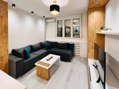 a living room with a couch and a table at Vivio 2 Luxury Apartment in Belgrade