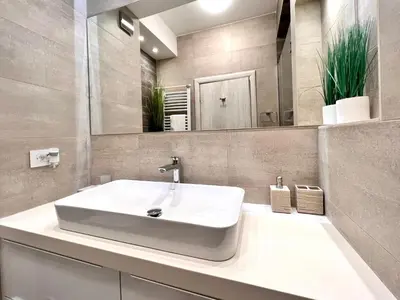 a bathroom with a white sink and a mirror at Vivio 2 Luxury Apartment in Belgrade