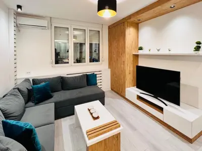 a living room with a couch and a flat screen tv at Vivio 2 Luxury Apartment in Belgrade