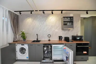 a kitchen with a washing machine and a washer and dryer at River&Bike Apartment in Belgrade