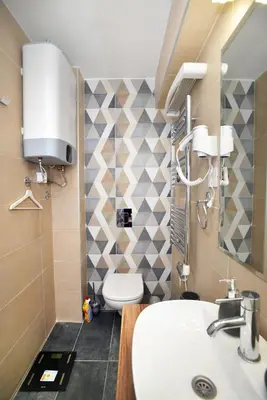 a bathroom with a white sink and a toilet at River&Bike Apartment in Belgrade