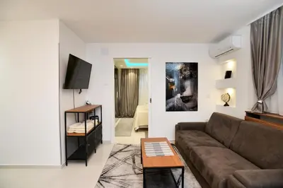 a living room with a couch and a tv at River&Bike Apartment in Belgrade