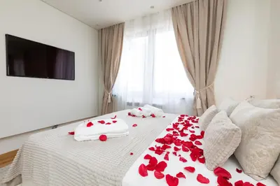 a bedroom with red roses on a bed at Belgrade Waterfront Apartments - River View in Belgrade
