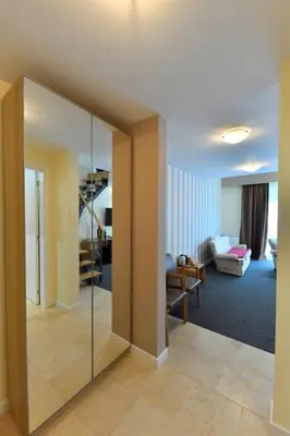 a living room with a large mirror in a room at Villa Luxury Rooms - Wine Resort in Smederevo