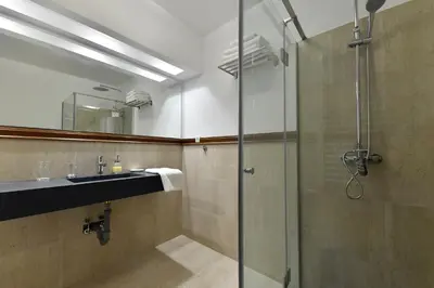 a bathroom with a glass shower and a sink at Villa Luxury Rooms - Wine Resort in Smederevo