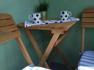a wooden table with two coffee cups on it at Downtown lux in Smederevo