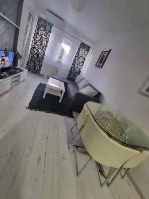 a living room with a glass table and a couch at Downtown lux in Smederevo