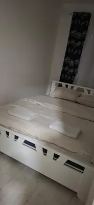 a white bed in a white room with at Downtown lux in Smederevo