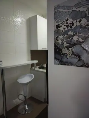 a kitchen with a stool and a counter and a sink at Downtown lux in Smederevo