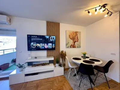 a living room with a table and a tv at Belgrade Apartment 3 in Zvezdara