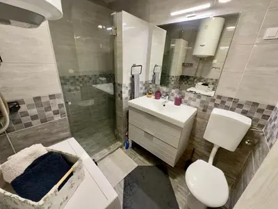 a bathroom with a toilet and a sink and a shower at Belgrade Apartment 3 in Zvezdara