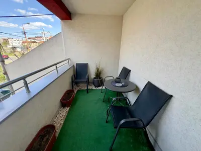 a balcony with a table and chairs on a building at Belgrade Apartment 3 in Zvezdara