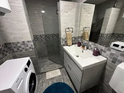 a bathroom with a sink and a washing machine at Belgrade Apartment 3 in Zvezdara
