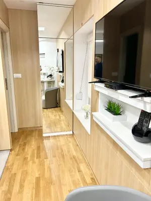 a living room with a large television on a wall at Paradise Museum City Center in Belgrade