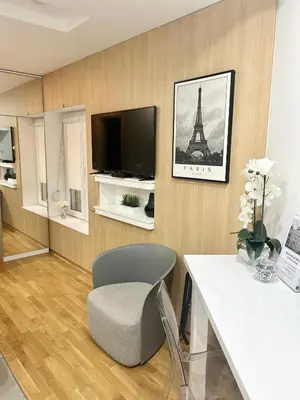 a living room with a table and a tv and a chair at Paradise Museum City Center in Belgrade
