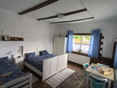 a bedroom with two beds and a table and a dining room at Matejev konak in Šušara