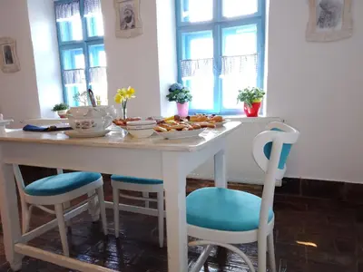 a table with chairs and a plate of food on it at Matejev konak in Šušara