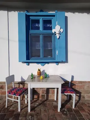 a table with two chairs and a blue cabinet at Matejev konak in Šušara
