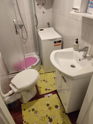 a small bathroom with a toilet and a sink at Orion Apatman in Belgrade