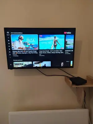 a flat screen tv hanging on a wall at Orion Apatman in Belgrade