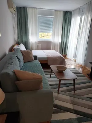 a living room with a couch and a bed at Green 1 in Belgrade