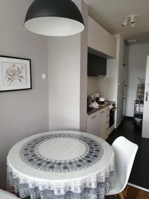a dining room table with a white table cloth on it at Green 1 in Belgrade