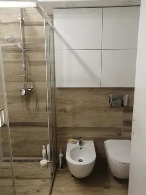 a bathroom with a shower and a toilet and a sink at Green 1 in Belgrade