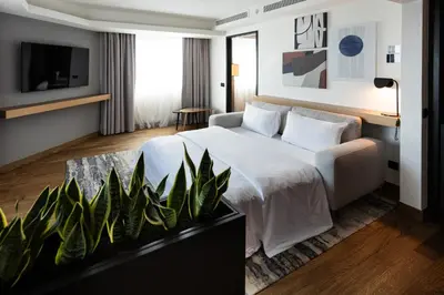 a hotel room with a bed and a tv at Crowne Plaza Belgrade by IHG in Belgrade
