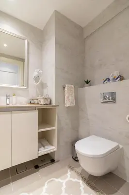 a white bathroom with a toilet and a sink at Belgrade Waterfront Studio Apartment-Supertwins in Sajmište