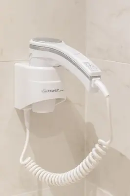 a white phone hanging on a wall in a bathroom at Belgrade Waterfront Studio Apartment-Supertwins in Sajmište