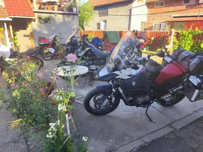 a group of motorcycles parked in a yard at Stan na dan studio in Inđija
