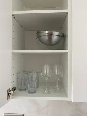 a cupboard with wine glasses and a bowl in it at Hidden Gem in Belgrade