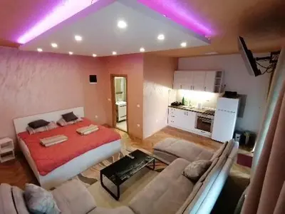 a living room with a bed and a couch at Pelegrino in Stara Pazova