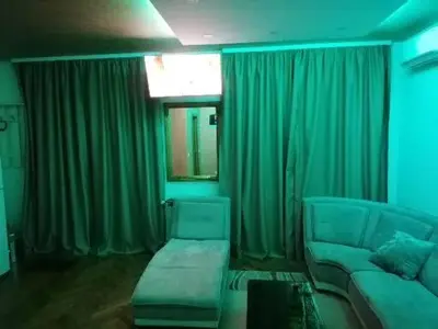 a living room with green curtains and a couch at Pelegrino in Stara Pazova