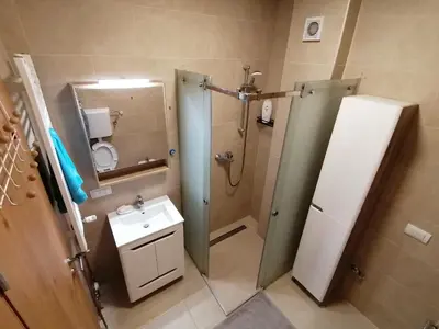 a bathroom with a sink and a shower with a mirror at Pelegrino in Stara Pazova