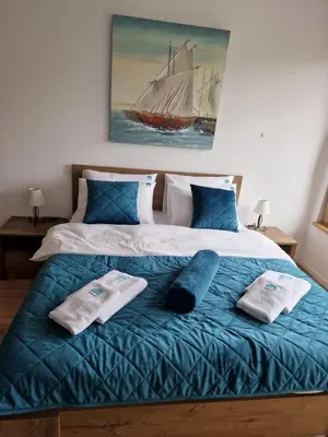 a bedroom with a large bed with towels on it at BulevarD Apartment in Belgrade