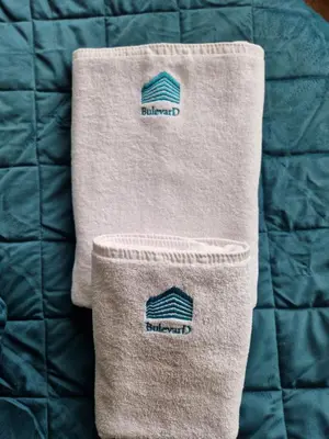 a blanket with a towel on top of a bed at BulevarD Apartment in Belgrade