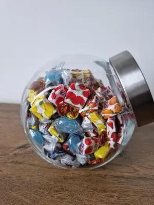 a glass jar filled with candy melts at BulevarD Apartment in Belgrade