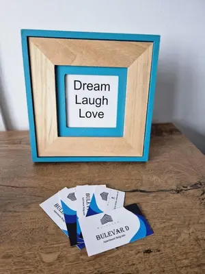 a picture frame with a sign that says dream laugh love at BulevarD Apartment in Belgrade