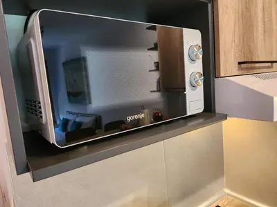 a microwave oven sitting on top of a kitchen counter at BulevarD Apartment in Belgrade