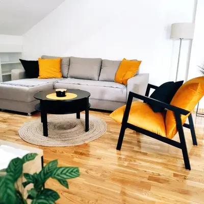 a living room with a couch and a table and a chair at Apartman Blagojevic Hill in Arandjelovac