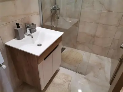 a bathroom with a sink and a shower at Apartman Blagojevic Hill in Arandjelovac