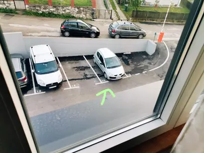 a view of cars parked in a parking lot at Apartman Blagojevic Hill in Arandjelovac