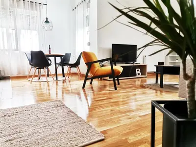a living room with a table and chairs at Apartman Blagojevic Hill in Arandjelovac