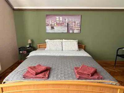 a bedroom with a bed with two red pillows on it at Apartman Stojanović in Arandjelovac