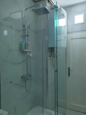 a bathroom with a shower with a glass door at Apartman Stojanović in Arandjelovac