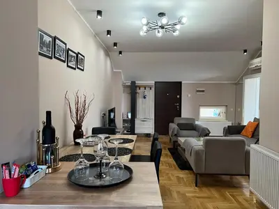 a living room with a table and a couch at Apartman Stojanović in Arandjelovac